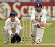 Tim Ambrose watches as Ian Bell reverse sweeps Mark Davis