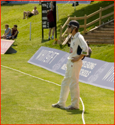 Joe Denly wears a helmet on the boundary, Whitgift School