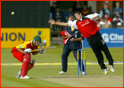 Bowler Dean Cosker fields by a crouching Iain Sutcliffe