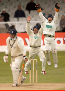 Shane Warne &  keeper Tom Burrows appeal in the cold