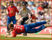 Tim Phillips fields off his own bowling against Kent