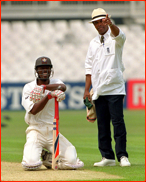 Chris Lewis is shown the (red) light by umpire John Holder