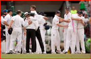 England (and umpires) hug, Sydney.